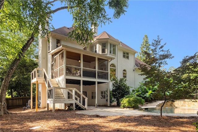 510 Northland Ridge Ct, Sandy Springs, GA 30342 - rear view of property featuring a sunroom, stairway, stucco siding, and a chimney