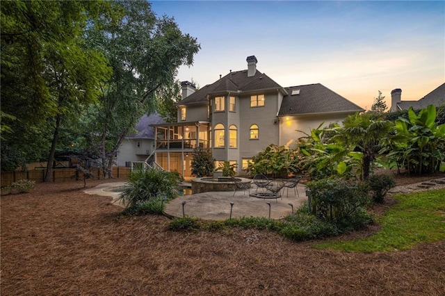 510 Northland Ridge Ct, Sandy Springs, GA 30342 - back of house at dusk featuring a patio, stairs, stucco siding, and a jacuzzi