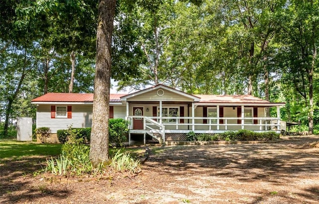 ranch-style house featuring metal roof and covered porch