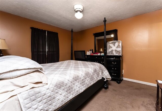 bedroom with carpet floors and a textured ceiling