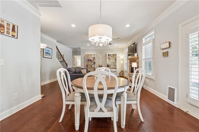 4650 Brighton View Trl, Cumming, GA 30040 - dining room featuring visible vents, baseboards, an inviting chandelier, ornamental molding, and wood finished floors