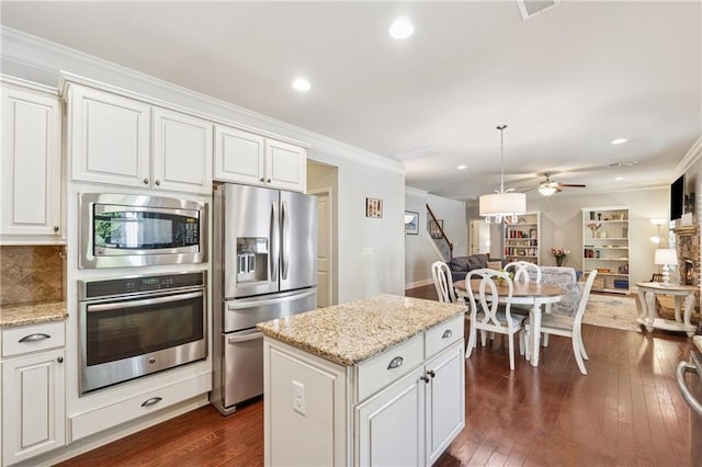 4650 Brighton View Trl, Cumming, GA 30040 - kitchen featuring a ceiling fan, dark wood finished floors, crown molding, stainless steel appliances, and backsplash