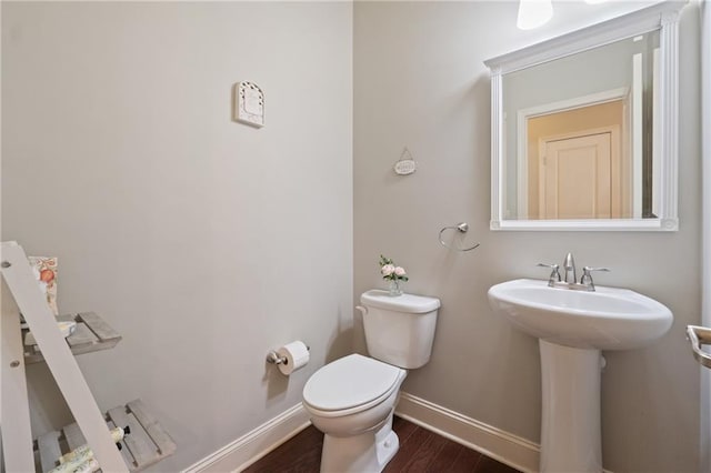 4650 Brighton View Trl, Cumming, GA 30040 - bathroom with baseboards, a sink, toilet, and wood finished floors