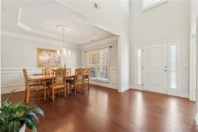 4650 Brighton View Trl, Cumming, GA 30040 - dining room with a raised ceiling, crown molding, dark wood-style floors, and visible vents