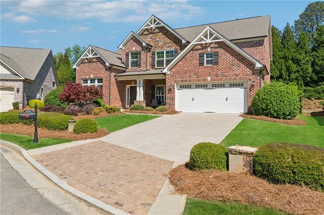 4650 Brighton View Trl, Cumming, GA 30040 - craftsman house with brick siding, a front yard, and concrete driveway