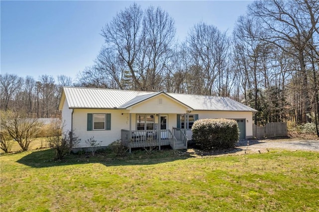 ranch-style house with a front yard, a porch, a garage, dirt driveway, and metal roof