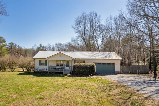 single story home featuring fence, gravel driveway, a porch, a front lawn, and metal roof