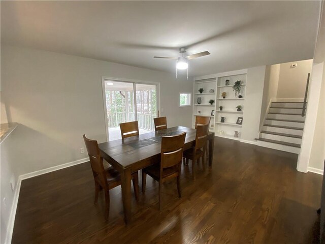 dining area featuring ceiling fan, baseboards, dark wood-style floors, and stairs