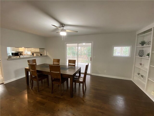 dining room with dark wood-style floors, baseboards, and ceiling fan
