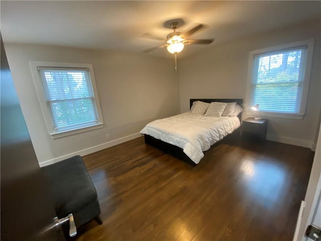 bedroom featuring ceiling fan, baseboards, and dark wood-style flooring