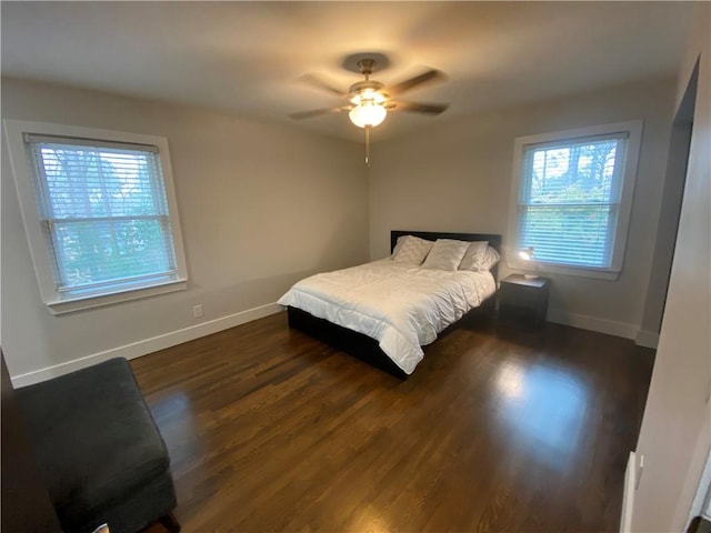 bedroom with dark wood finished floors, baseboards, and ceiling fan