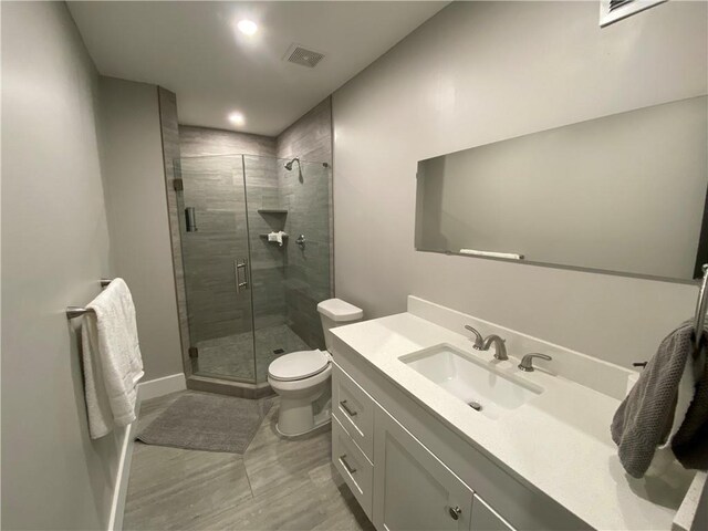 full bath with visible vents, a shower stall, toilet, recessed lighting, and vanity