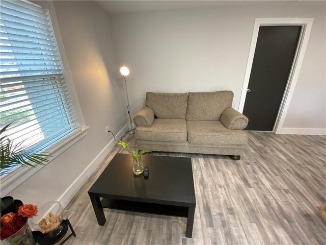 living area with wood finished floors and baseboards