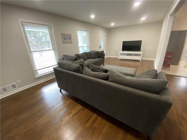 living area with recessed lighting, visible vents, baseboards, and dark wood-style flooring