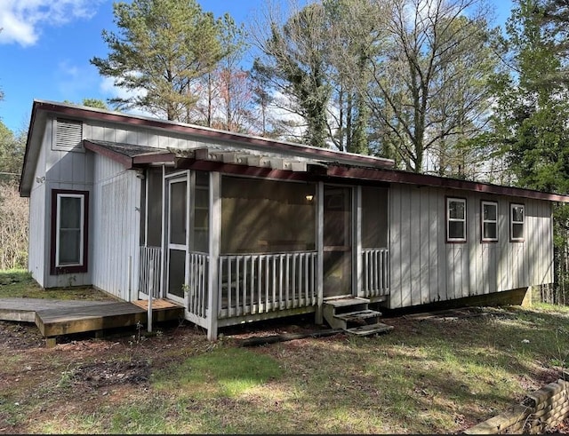 rear view of property with a sunroom