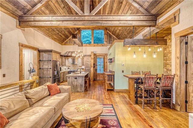 living room with light wood-type flooring, wood ceiling, and beamed ceiling