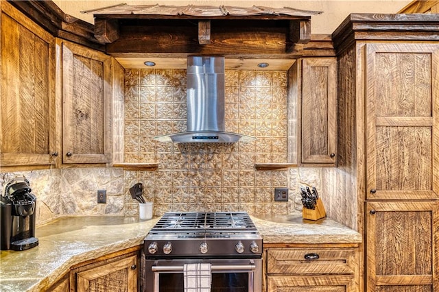 kitchen featuring backsplash, high end stove, and wall chimney exhaust hood