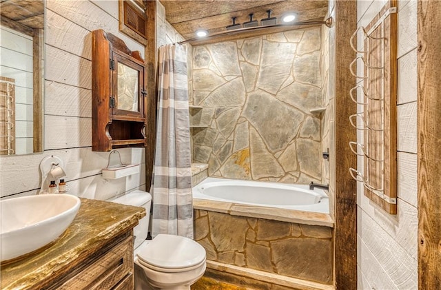 full bathroom featuring shower / bath combo, toilet, tile walls, and vanity