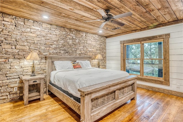 bedroom with light wood-type flooring, wood ceiling, and ceiling fan