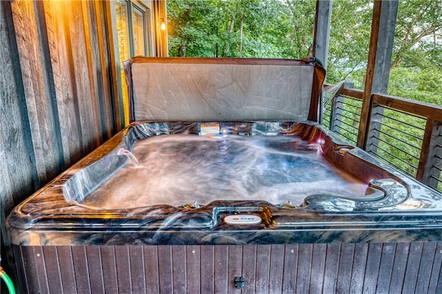 wooden deck with a hot tub