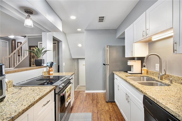 82 Twiggs Cor, Peachtree City, GA 30269 - kitchen with appliances with stainless steel finishes, a sink, white cabinetry, light wood-style floors, and recessed lighting