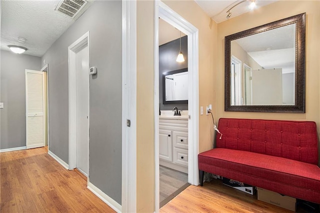 82 Twiggs Cor, Peachtree City, GA 30269 - hallway featuring wood finished floors, baseboards, and a sink