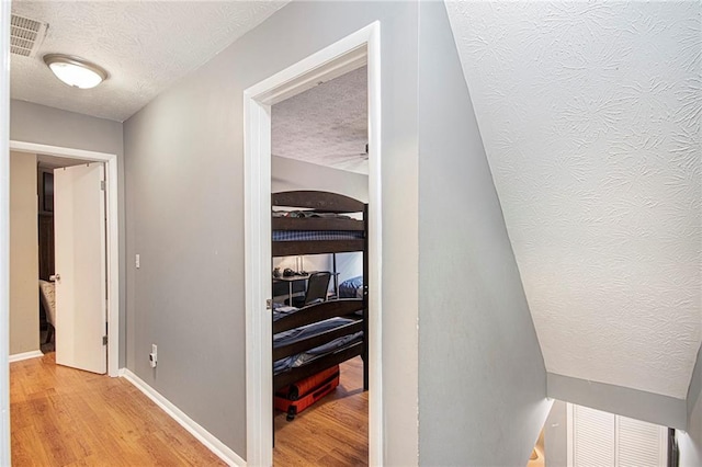 82 Twiggs Cor, Peachtree City, GA 30269 - hallway with a textured ceiling, light wood finished floors, and baseboards