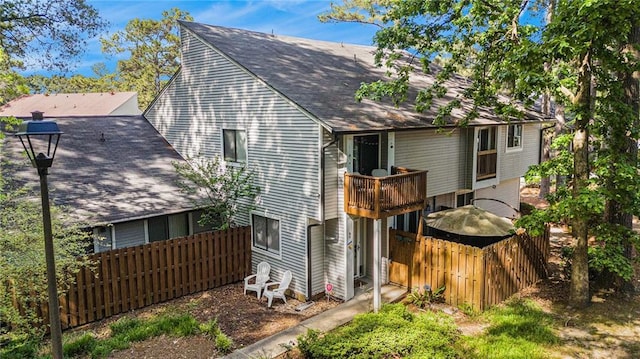 82 Twiggs Cor, Peachtree City, GA 30269 - rear view of house with a balcony and a shingled roof