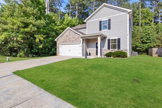 view of front of house featuring a garage and a front yard