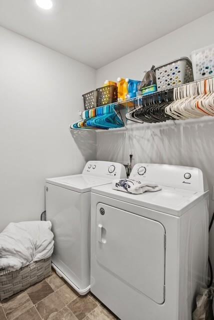 clothes washing area featuring washer and clothes dryer