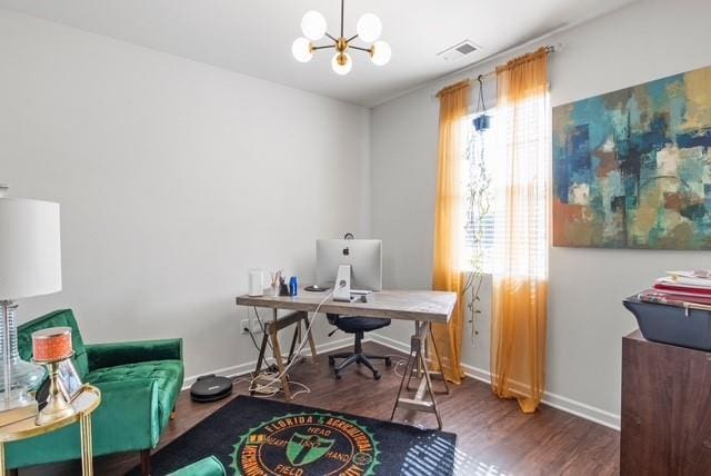 office space with dark wood-type flooring and an inviting chandelier