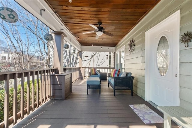 wooden terrace featuring an outdoor hangout area and a ceiling fan