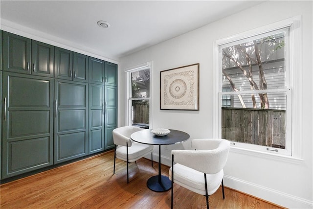 dining room with baseboards and light wood finished floors