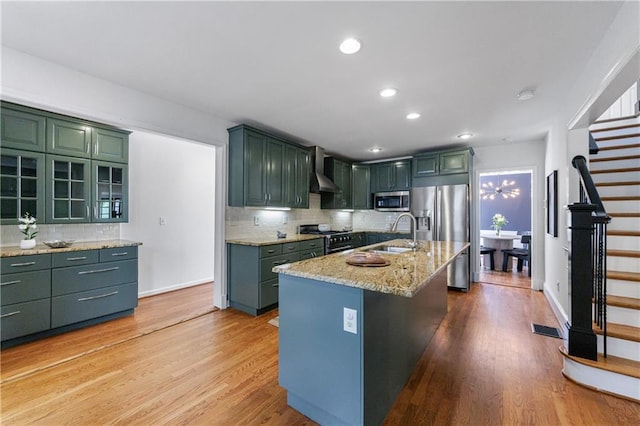 kitchen with tasteful backsplash, visible vents, appliances with stainless steel finishes, and a sink