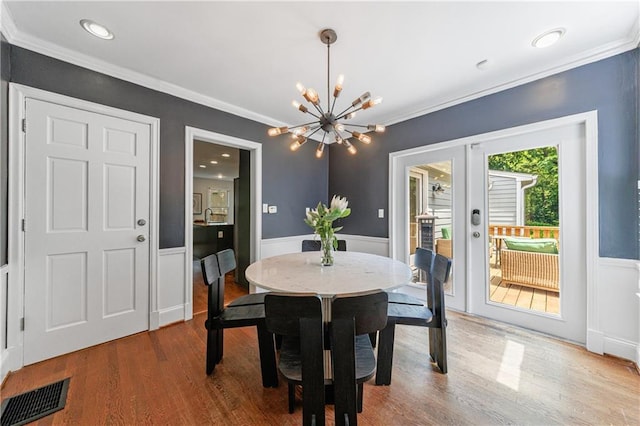 dining area featuring a chandelier, visible vents, french doors, and crown molding