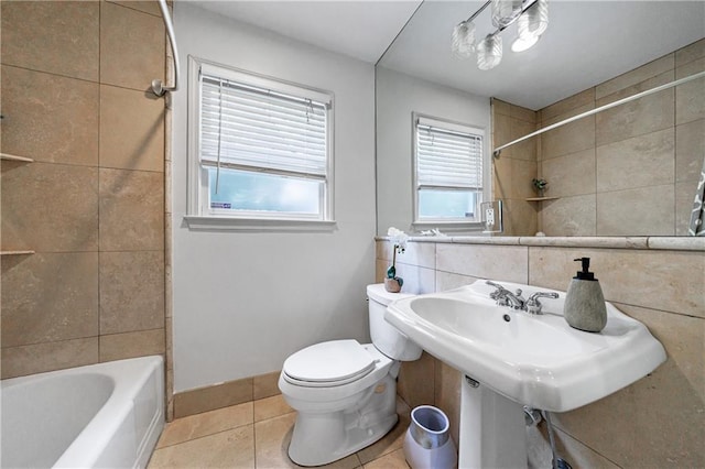 1349 Middlesex Ave NE, Atlanta, GA 30306 - bathroom featuring tile patterned flooring, toilet, tile walls, washtub / shower combination, and baseboards
