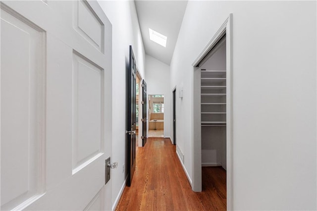 hall featuring baseboards and wood finished floors