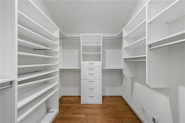 spacious closet featuring visible vents and wood finished floors