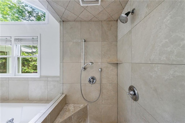 bathroom featuring tiled shower and a garden tub