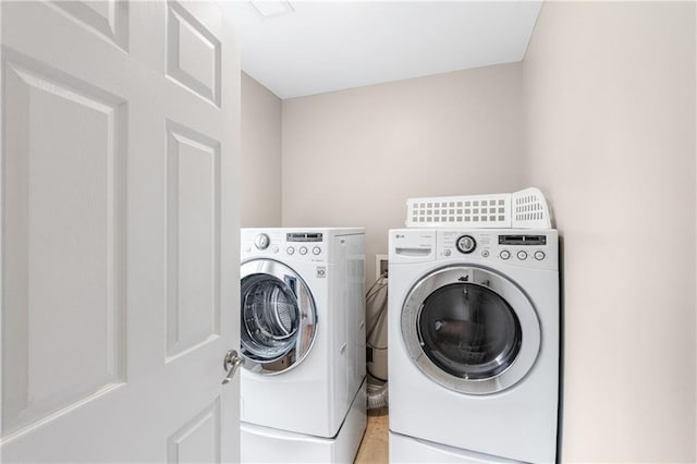 clothes washing area with washer and dryer and laundry area