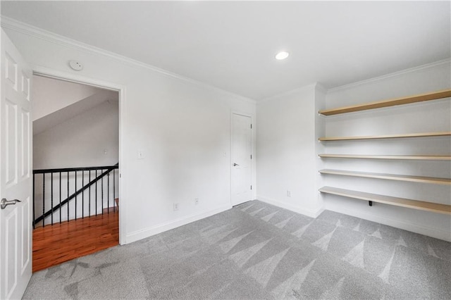 carpeted empty room featuring crown molding, recessed lighting, and baseboards