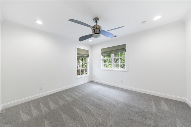 carpeted spare room with crown molding, recessed lighting, a ceiling fan, and baseboards