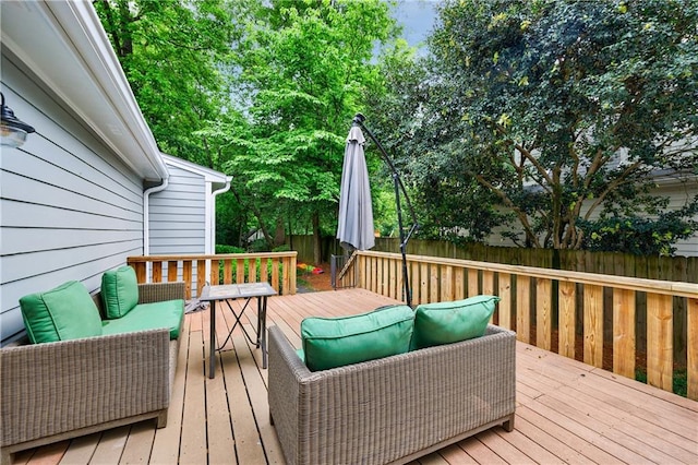 wooden deck featuring outdoor lounge area and fence