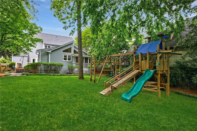 view of jungle gym featuring fence and a yard
