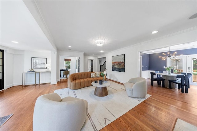 living room featuring ornamental molding, recessed lighting, light wood-style flooring, and baseboards
