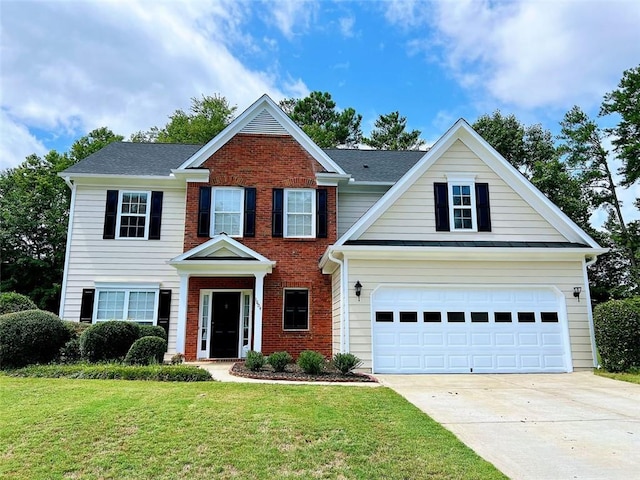 view of front of house with a front yard and a garage