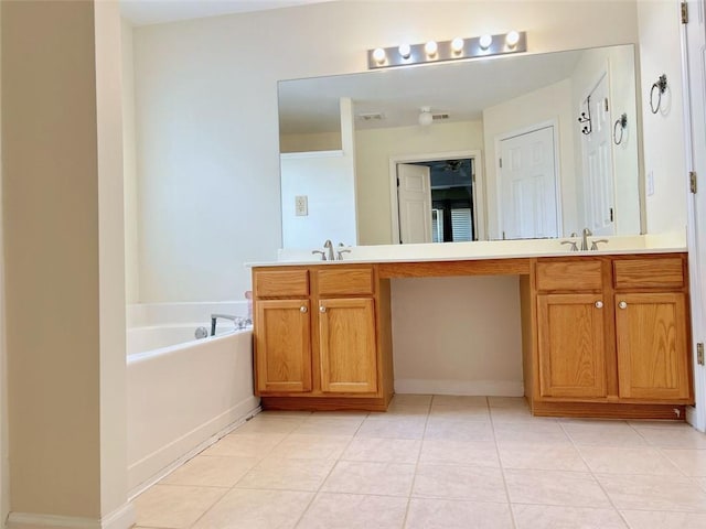 bathroom with vanity, tile patterned floors, and a bathing tub