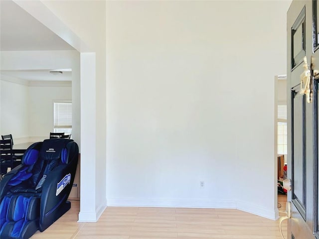 hallway with light hardwood / wood-style floors