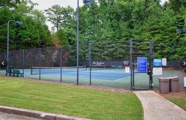 view of tennis court with a lawn