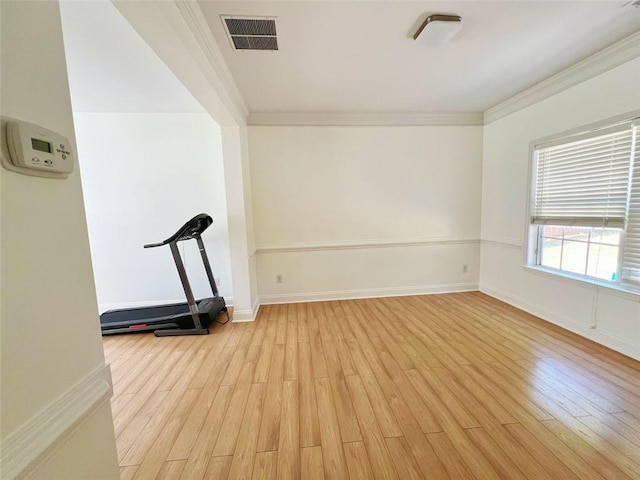 interior space with crown molding and light hardwood / wood-style floors